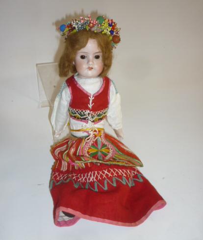 A German bisque shoulder head doll with brown glass sleeping eyes Image