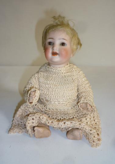A Kammer & Reinhardt bisque head doll with brown glass sleeping eyes Image