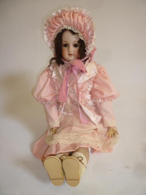 An Armand Marseille bisque head doll with brown glass sleeping eyes Image