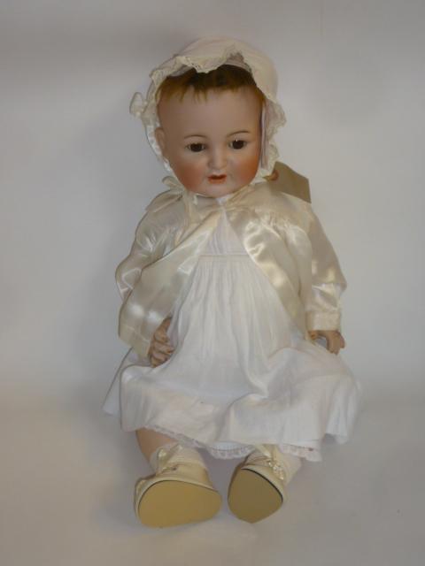 A Kammer & Reinhardt bisque head doll with brown glass sleeping eyes Image
