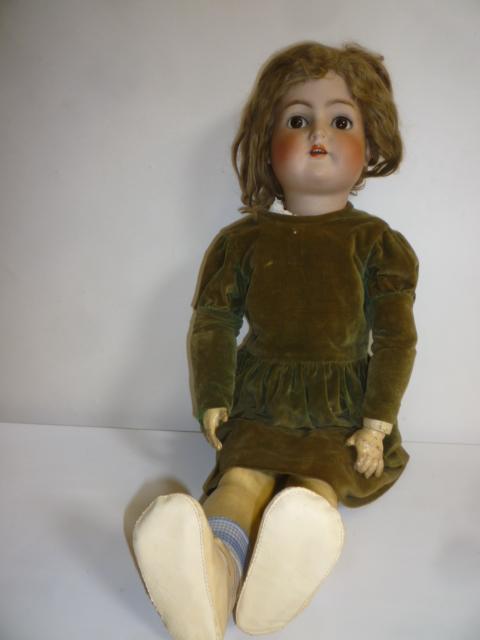 A Kammer & Reinhardt bisque head walking doll with brown glass sleeping eyes Image