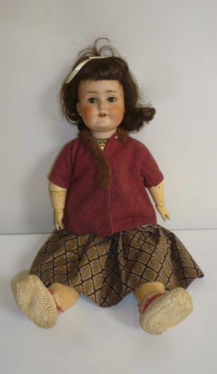 A Schoenau & Hoffmeister bisque head doll with blue glass sleeping eyes Image
