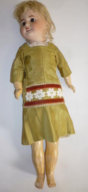 A French SFBJ bisque head doll with fixed brown glass eyes Image
