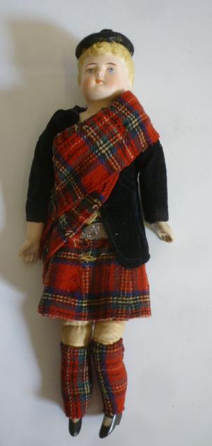 A bisque shoulder head doll with intaglio eyes Image