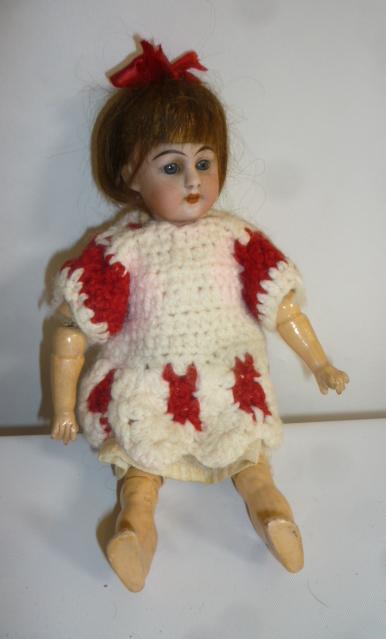 A Simon & Halbig bisque head doll with blue glass sleeping eyes Image