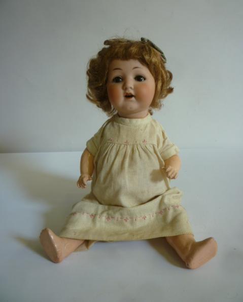 An Armand Marseille bisque head character doll with brown glass sleeping eyes Image