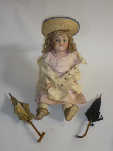 A Heinrich Handwerck bisque head doll with blue glass sleeping eyes Image