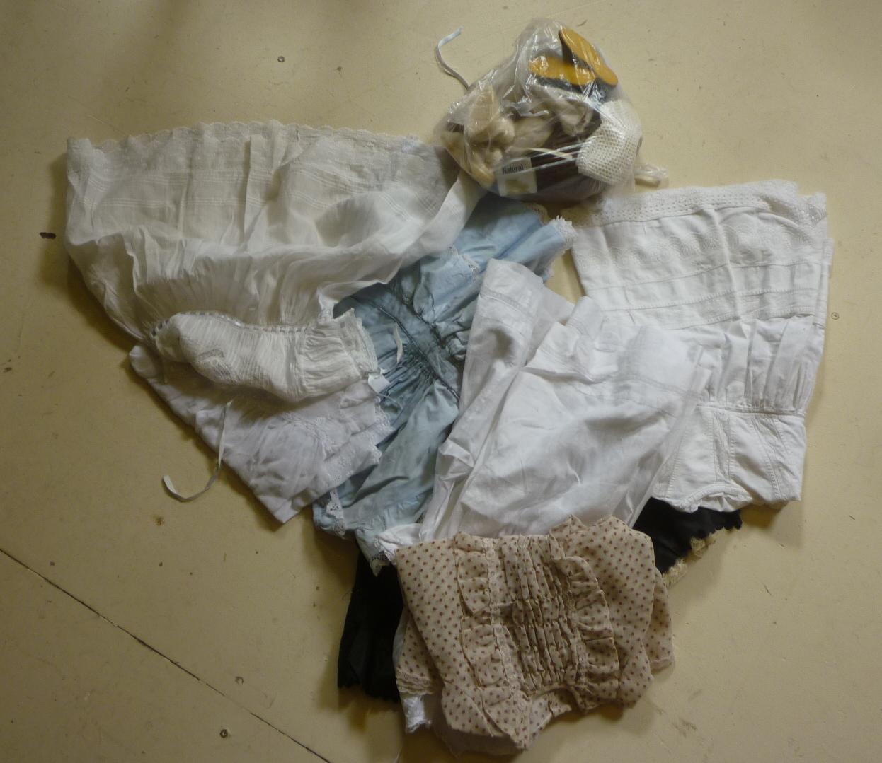 A quantity of dolls' clothing in cotton Image