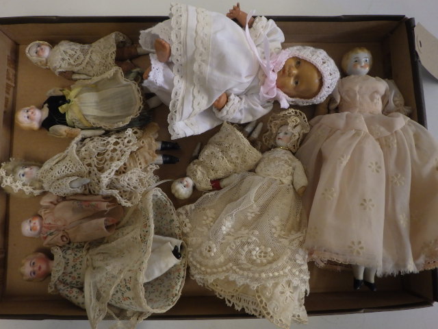 A collection of eight doll's house and miniature bisque head dolls Image