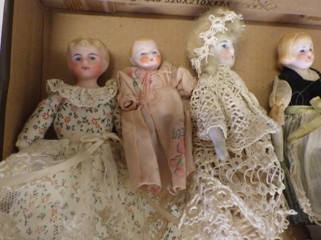 A collection of eight doll's house and miniature bisque head dolls Image