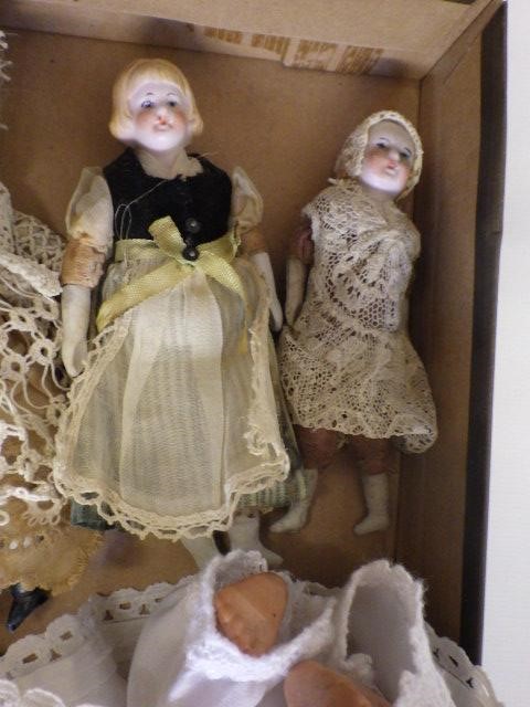 A collection of eight doll's house and miniature bisque head dolls Image