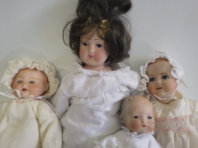 Four bisque head dolls comprising two Armand Marseille baby dolls with sleeping eyes Image