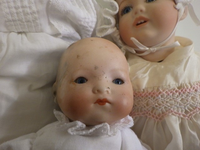 Four bisque head dolls comprising two Armand Marseille baby dolls with sleeping eyes Image