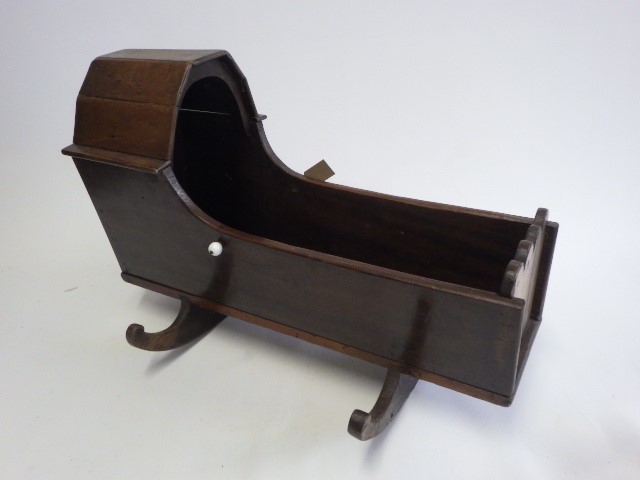 A Victorian mahogany doll's crib Image