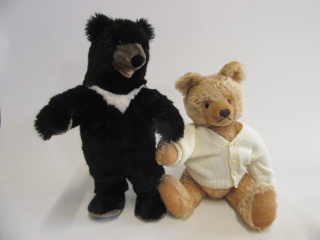 A Steiff black bear standing on it's hind legs Image