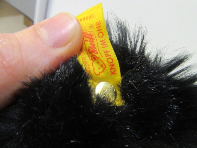 A Steiff black bear standing on it's hind legs Image