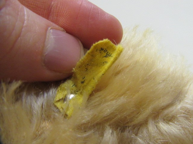 A Steiff black bear standing on it's hind legs Image