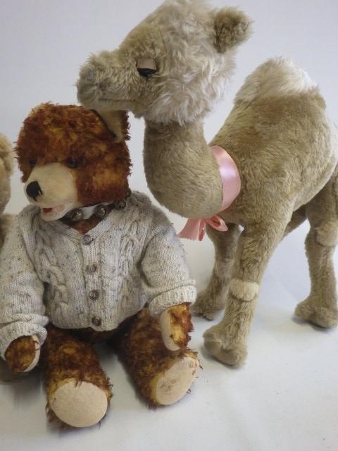 Four stuffed animals comprising a large camel Image
