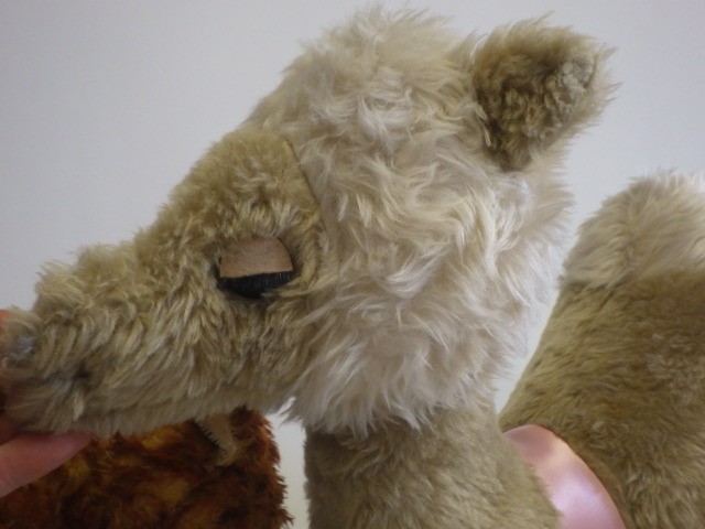 Four stuffed animals comprising a large camel Image