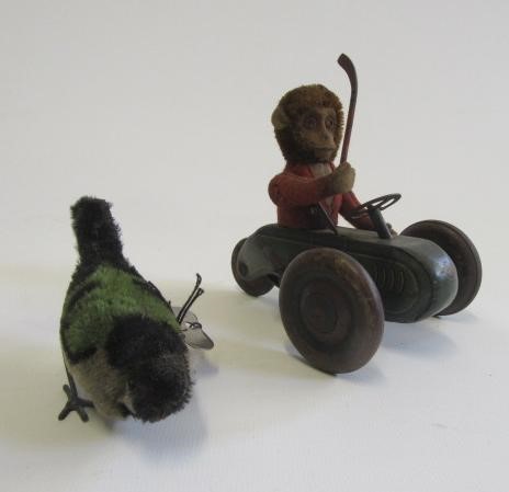 Early Schuco clockwork monkey in tricycle with hockey stick Image