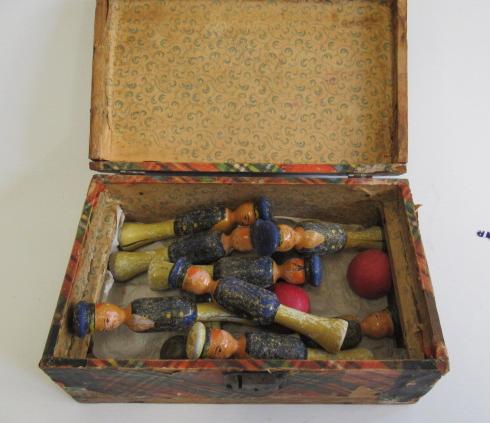 Late 19th century wooden skittles with nine carved wooden sailors and wooden balls in paper covered Image