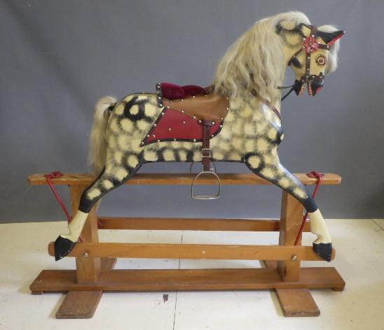 A carved wood rocking horse in dappled grey Image