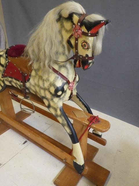 A carved wood rocking horse in dappled grey Image