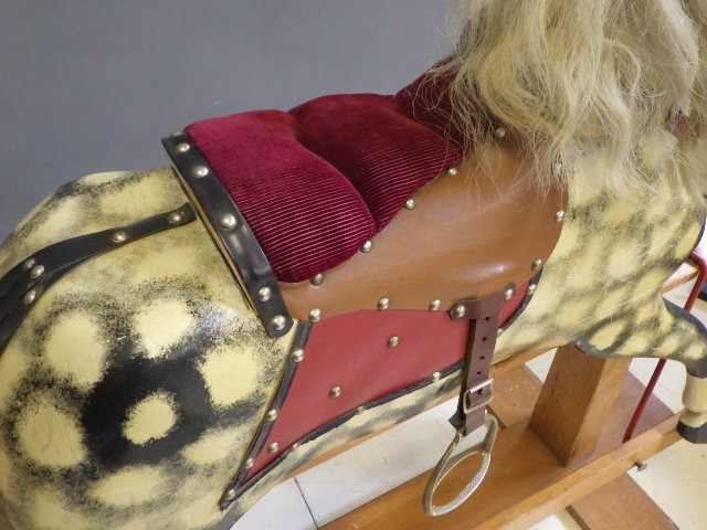 A carved wood rocking horse in dappled grey Image