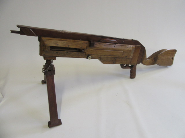A handmade wooden gun which fires rubber bands with removable bipod Image