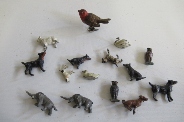 Fifteen small lead animals including dogs and birds Image