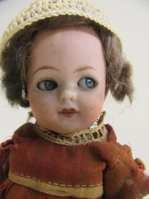 A Heubach bisque socket head flirty doll Image