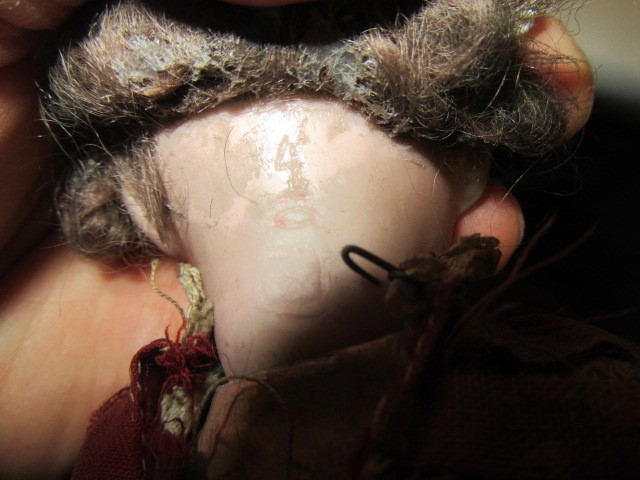 A Heubach bisque socket head flirty doll Image