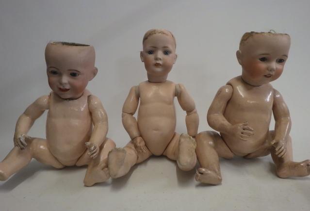 Three damaged bisque socket head dolls Image