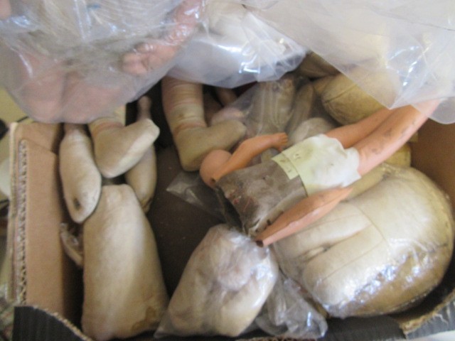 A quantity of spare doll parts including bisque heads Image