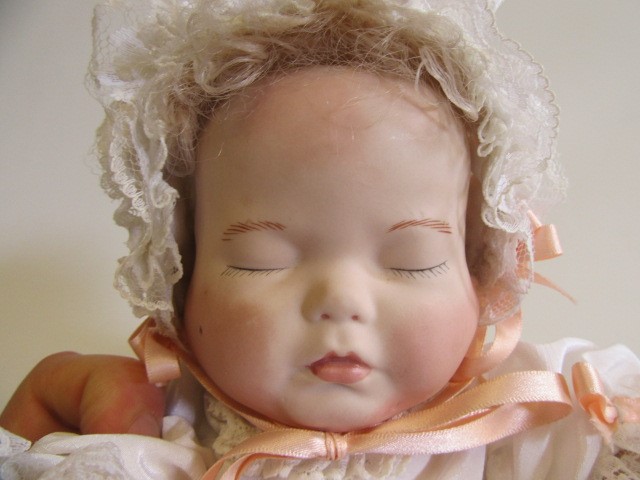 A late 20th century bisque multi-faced character doll Image