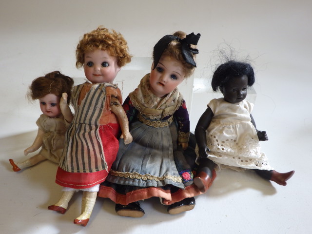Four small bisque head dolls Image