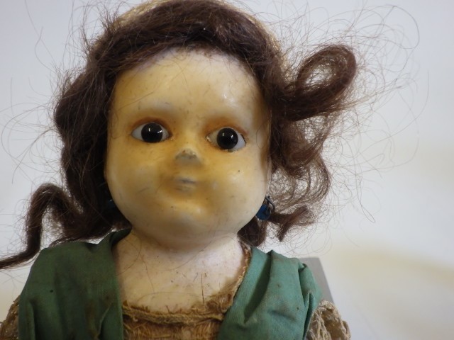 A small wax shoulder head doll Image