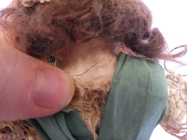 A small wax shoulder head doll Image