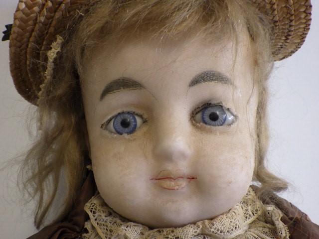 A 19th century wax shoulder head doll Image