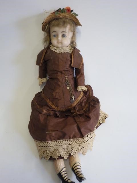 A 19th century wax shoulder head doll Image