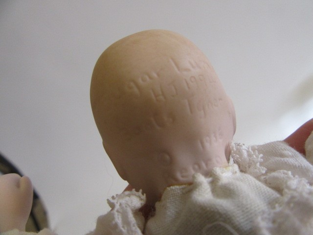 Four late 20th century bisque head dolls Image