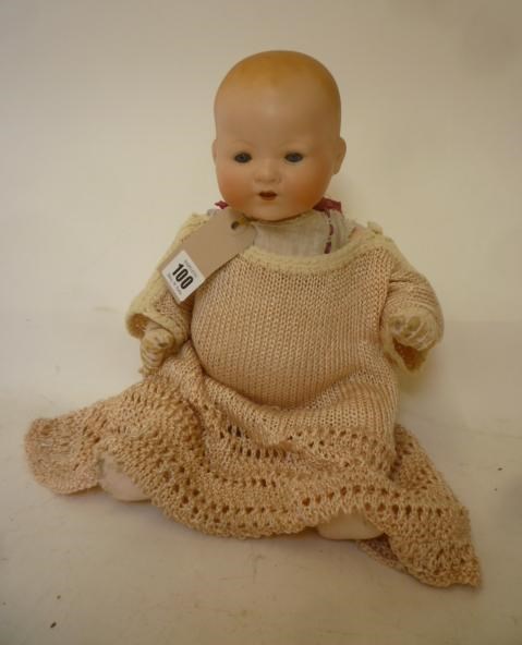 An Armand Marseille bisque head baby doll with blue glass sleeping eyes Image