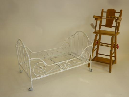 A wrought iron dolls cot Image