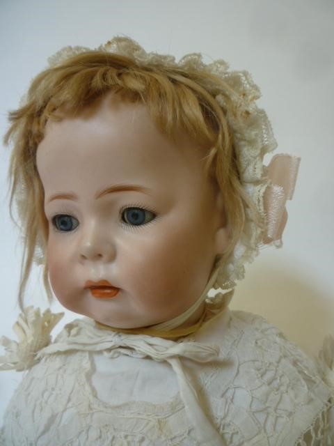A Kammer & Reinhardt bisque head character doll with blue glass sleeping eyes Image