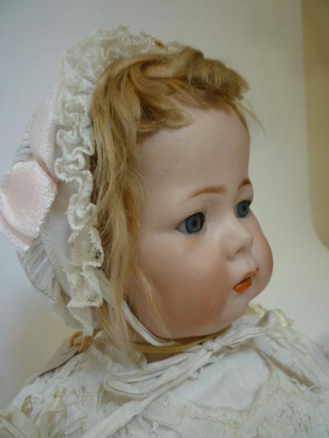 A Kammer & Reinhardt bisque head character doll with blue glass sleeping eyes Image