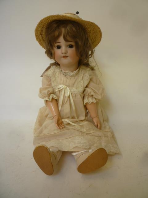 A Simon & Halbig bisque head girl doll with brown glass sleeping eyes Image