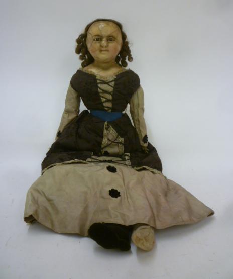 A wax shoulder head doll with fixed brown glass eyes Image