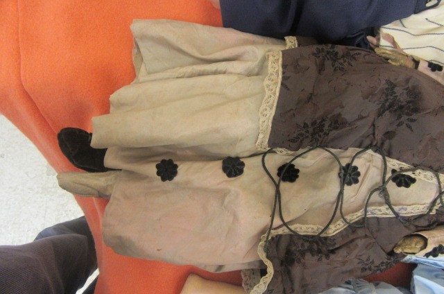 A wax shoulder head doll with fixed brown glass eyes Image