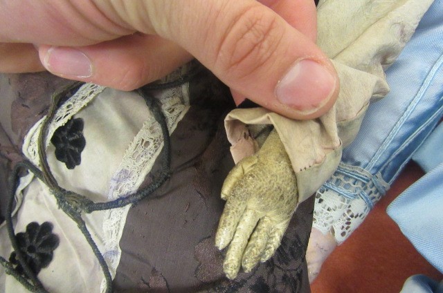 A wax shoulder head doll with fixed brown glass eyes Image