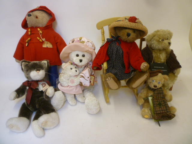 A Paddington Bear in red duffle coat and blue wellies Image